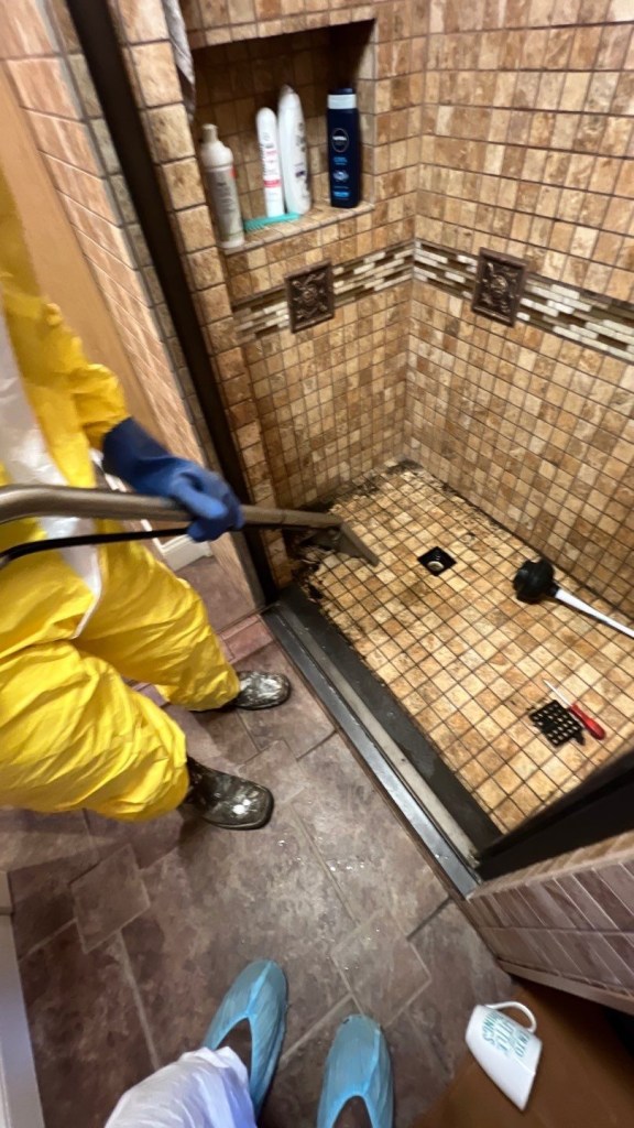 2 people in ppe doing sewage extraction 